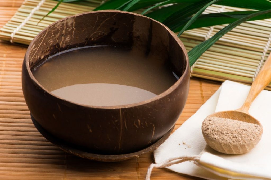 A picture showing a small amount of kava plant extract ready to be mixed with water.
