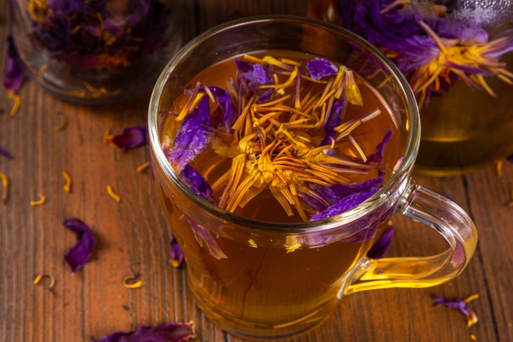 Traditional Blue Lotus Tea Prepared Using an Ancient Recipe, Served in a Transparent Mug